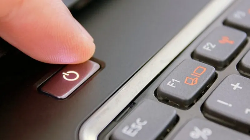 Người dùng thực hiện thao tác nhấn giữ nút nguồn trên bàn phím laptop để khởi động thiết bị